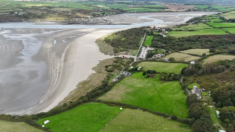 Long view along Poppit Sands beach